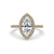 Diamond marquise engagement ring with a marquise cut diamond in a claw prong setting on a yellow gold ring band.
