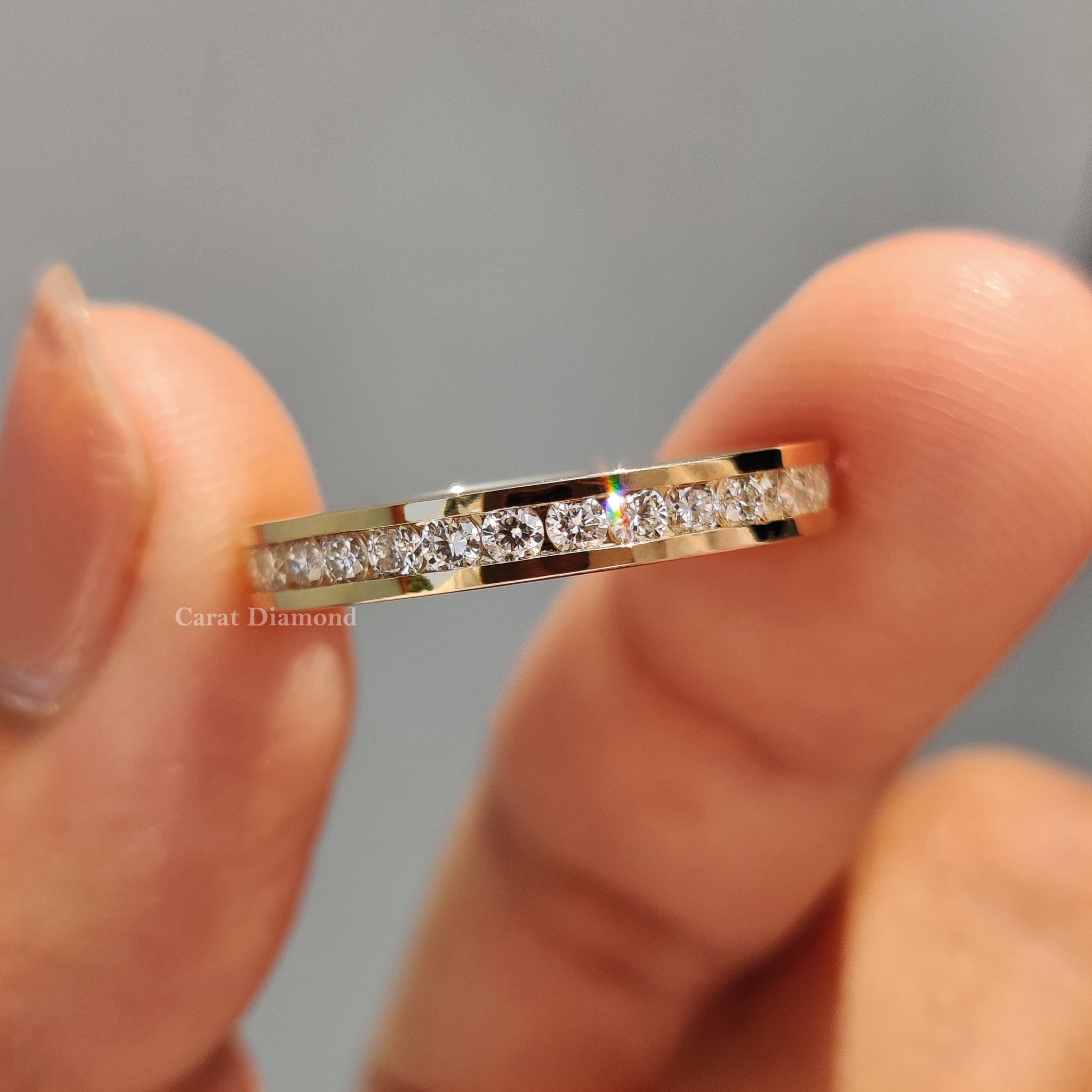 Channel set diamond band featuring a round diamond wedding band.
