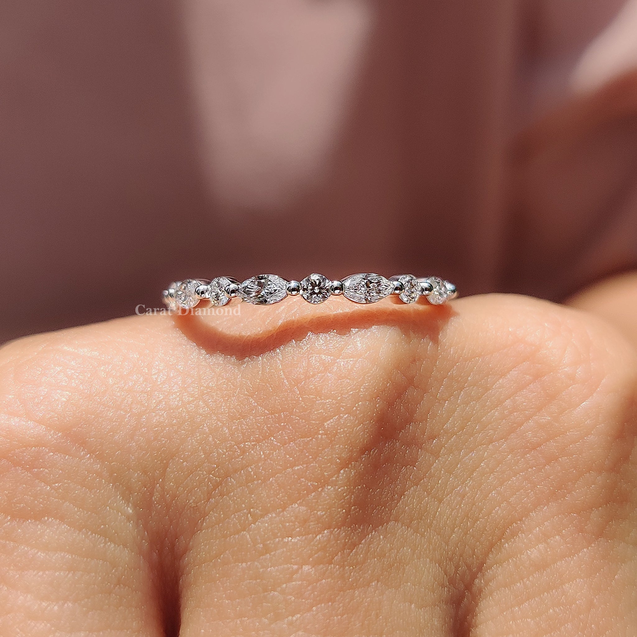 Round diamond band with marquise diamonds set in a shared prong eternity band.
