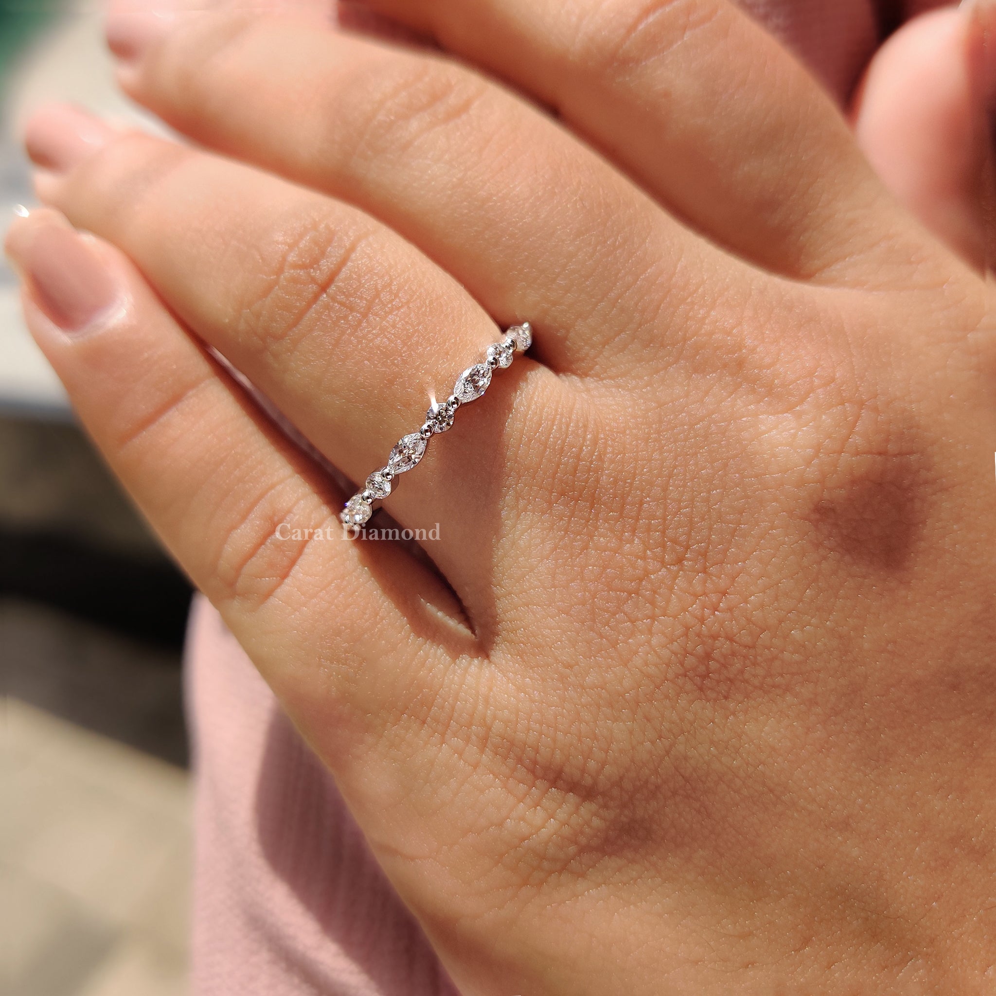 Shared prong eternity band featuring a marquise diamond band for a brilliant look.
