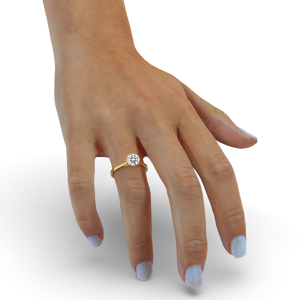 Bridge accent engagement ring featuring a round cut diamond, perfect for showcasing a contemporary yet timeless style.
