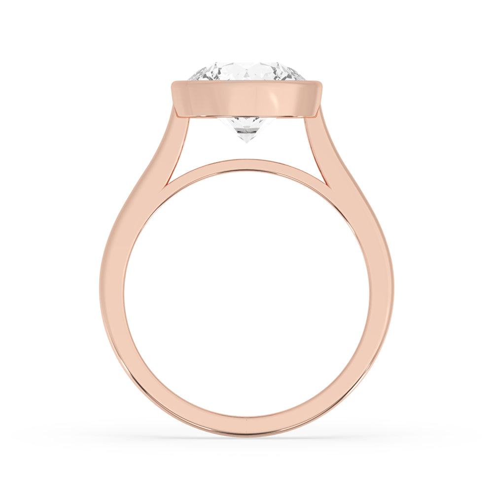 Gold ring round diamond with a minimalist bezel setting.