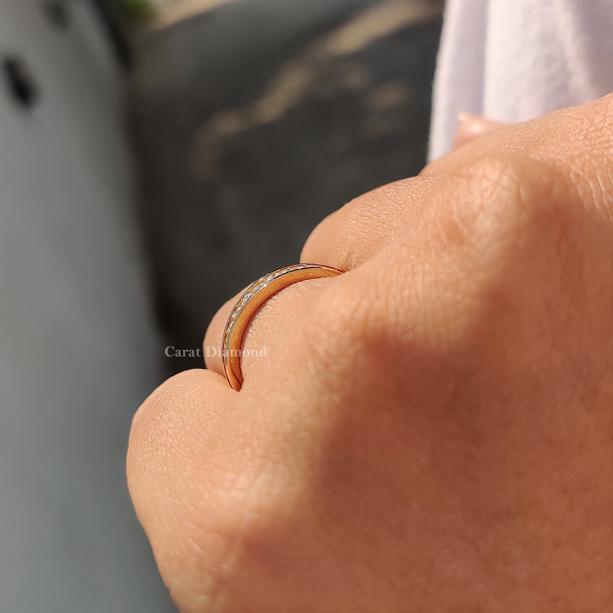 Channel set wedding band with round diamonds set in yellow gold.
