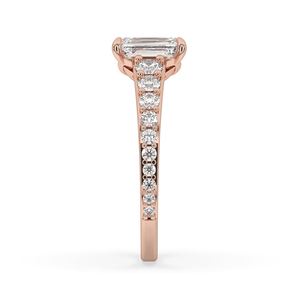 Emerald cut ring featuring pave setting and round diamond with side stones, crafted as a stunning handmade ring.
