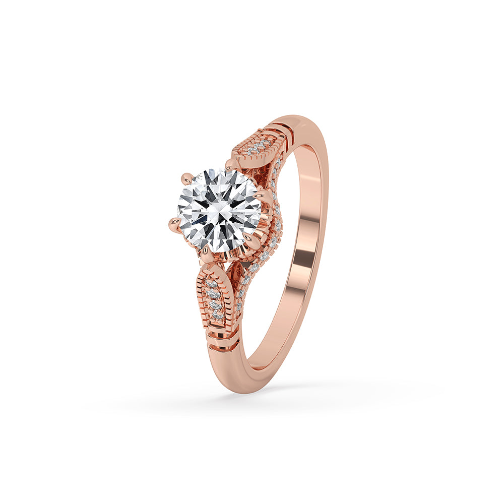 Vintage diamond engagement ring crafted in rose gold with intricate milgrain detailing and a unique bridge setting.