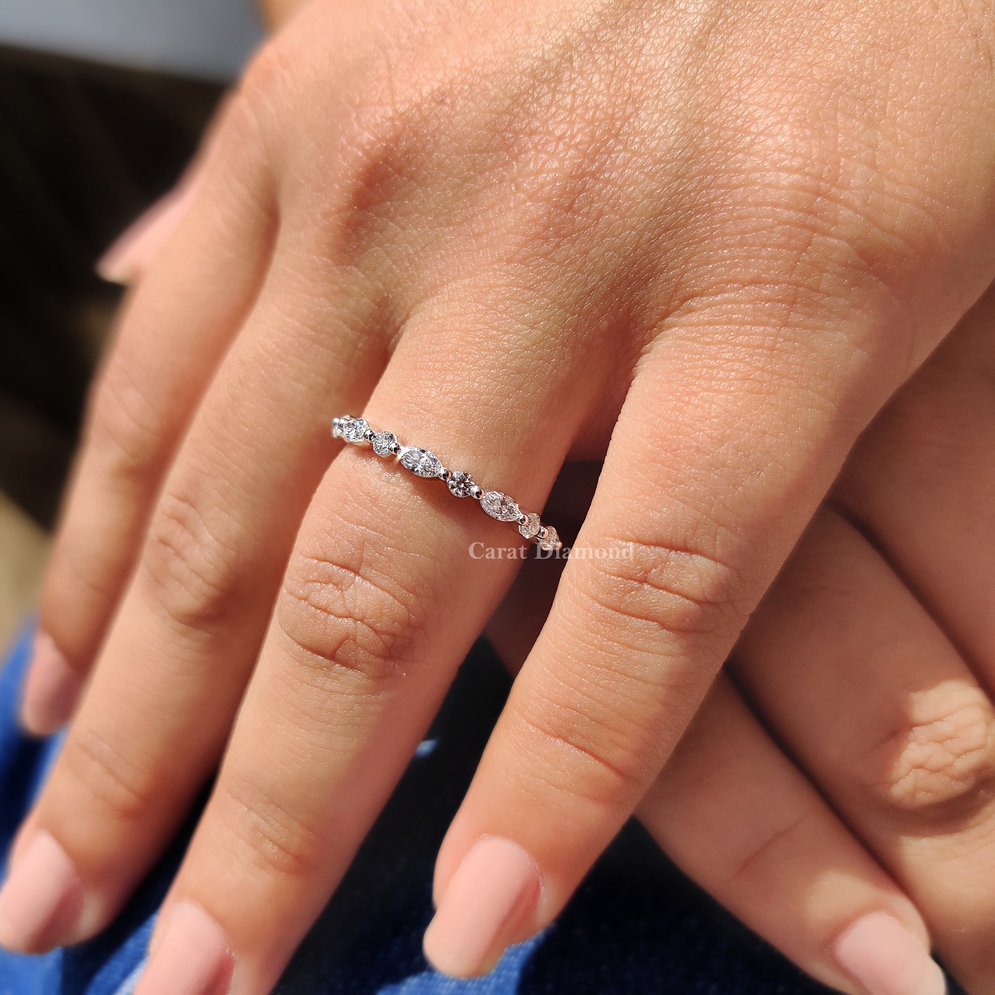 Half eternity wedding band set with marquise diamonds for timeless appeal.
