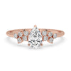 Gold pear shaped engagement ring with a prong setting ring and handmade jewelry design for timeless elegance.