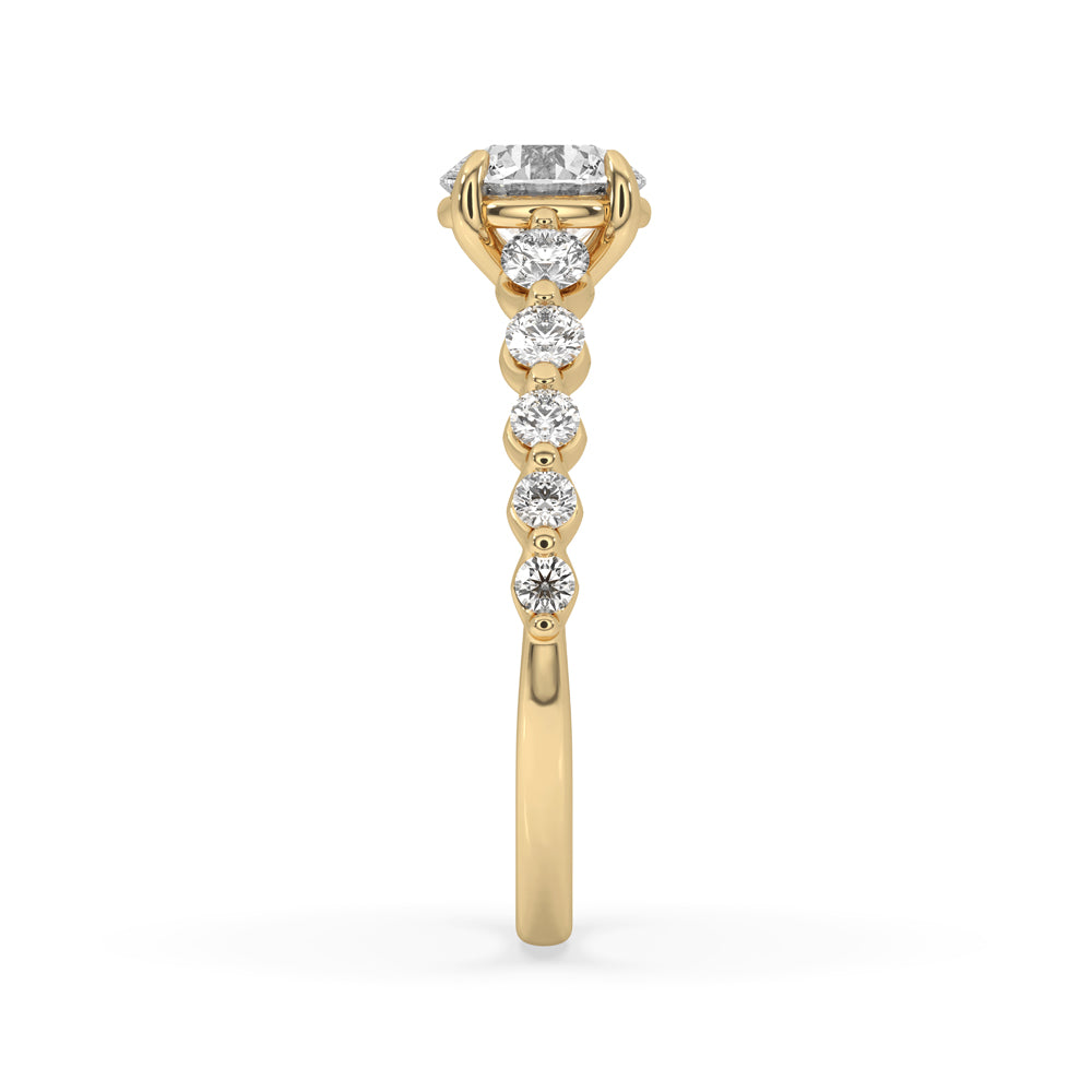 Round gold diamond ring with claw prongs and side stones, crafted for elegance and everyday wear.