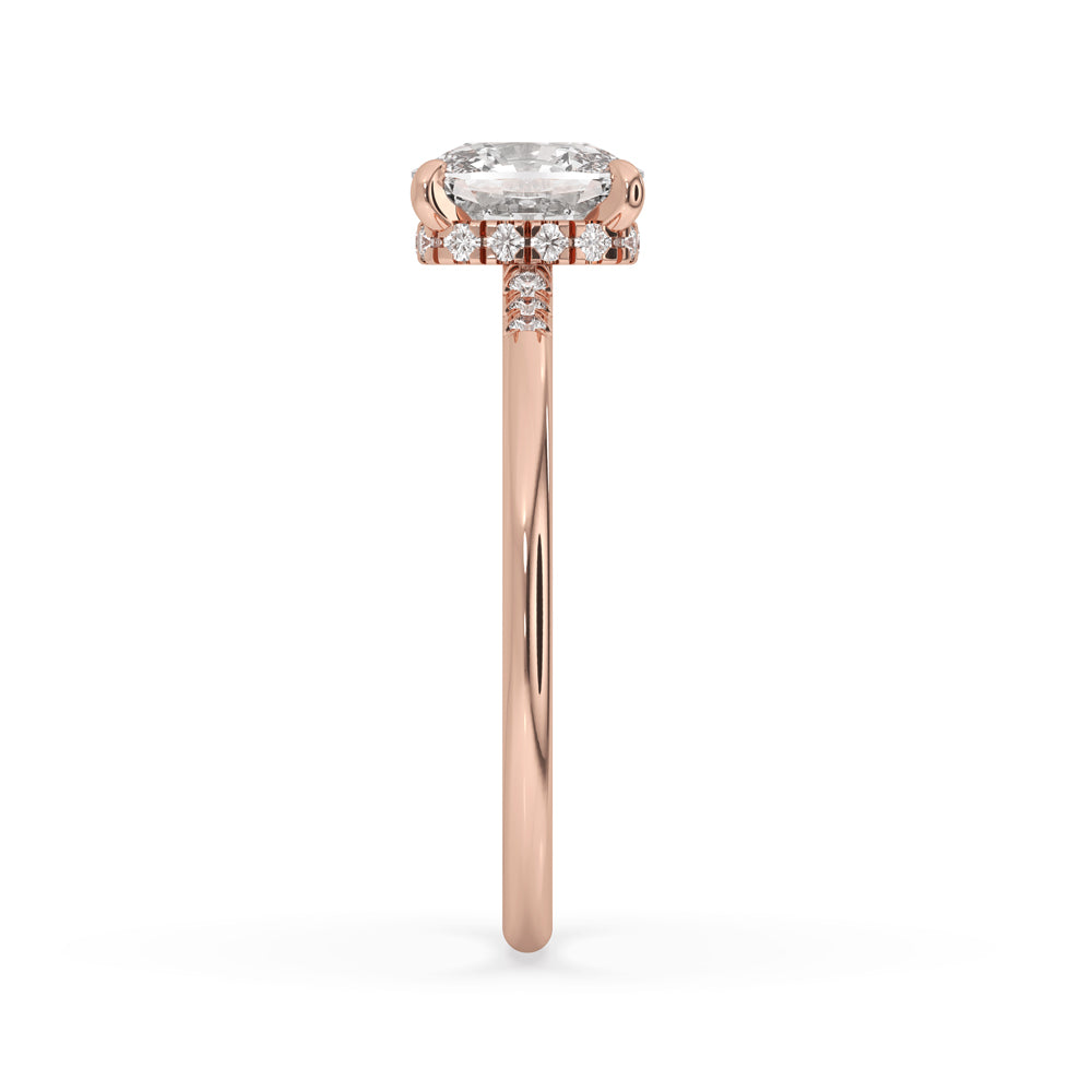 Elongated cushion diamond ring with side stones, showcasing a gold engagement ring in a stunning hidden halo design.