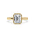 Emerald cut bezel ring displayed on a smooth marble surface.