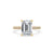 Emerald cut diamond engagement ring displayed on a neutral background.