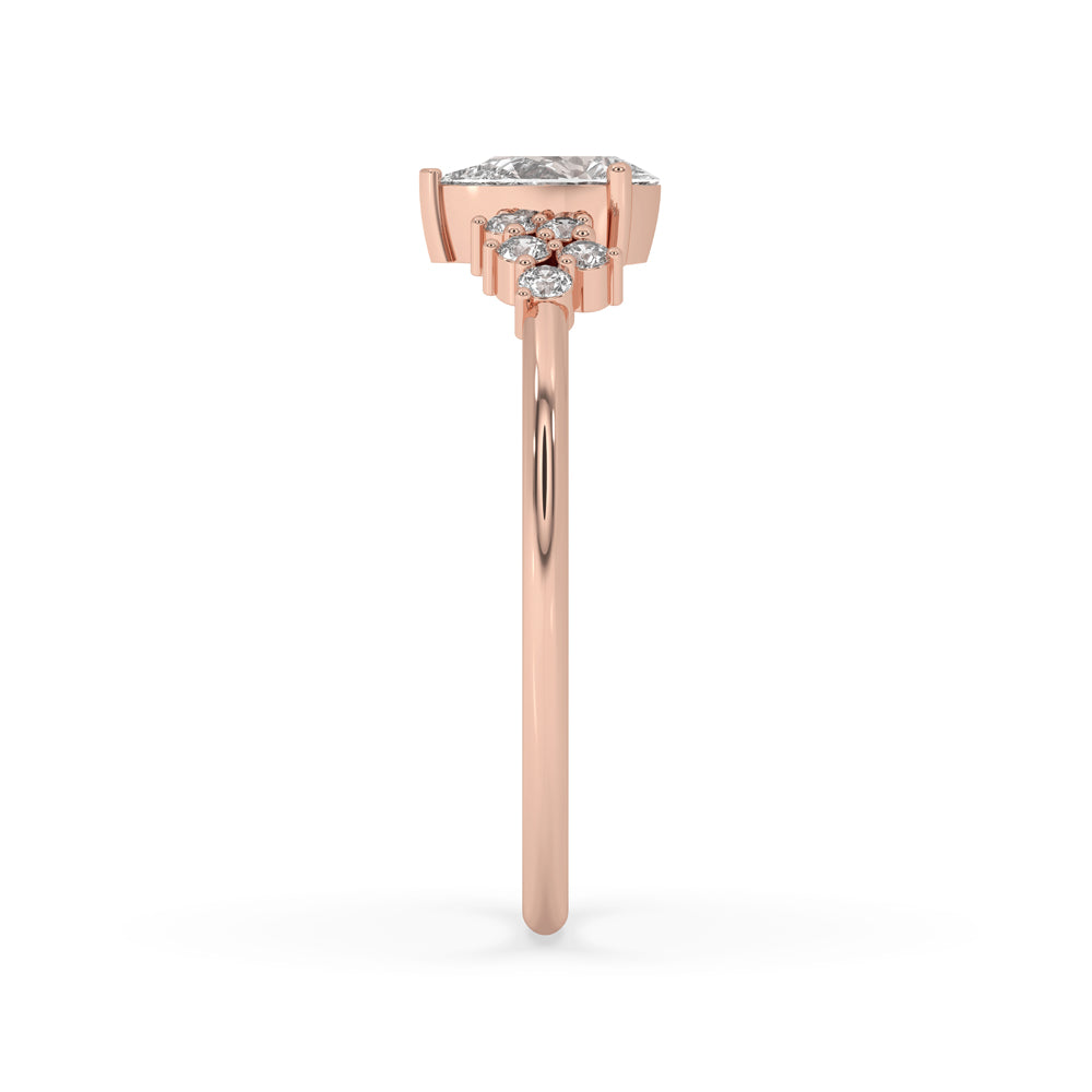 Pear ring with side stones in a heart prong ring design, featuring rose gold pear shaped ring craftsmanship.